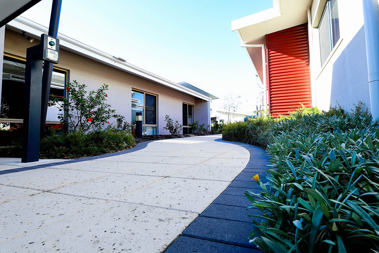 shifthomes-banner-image-2 A footpath with landscaping borders which leads to a home.