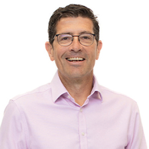 A photo of Adam Maxwell in a bright shirt.