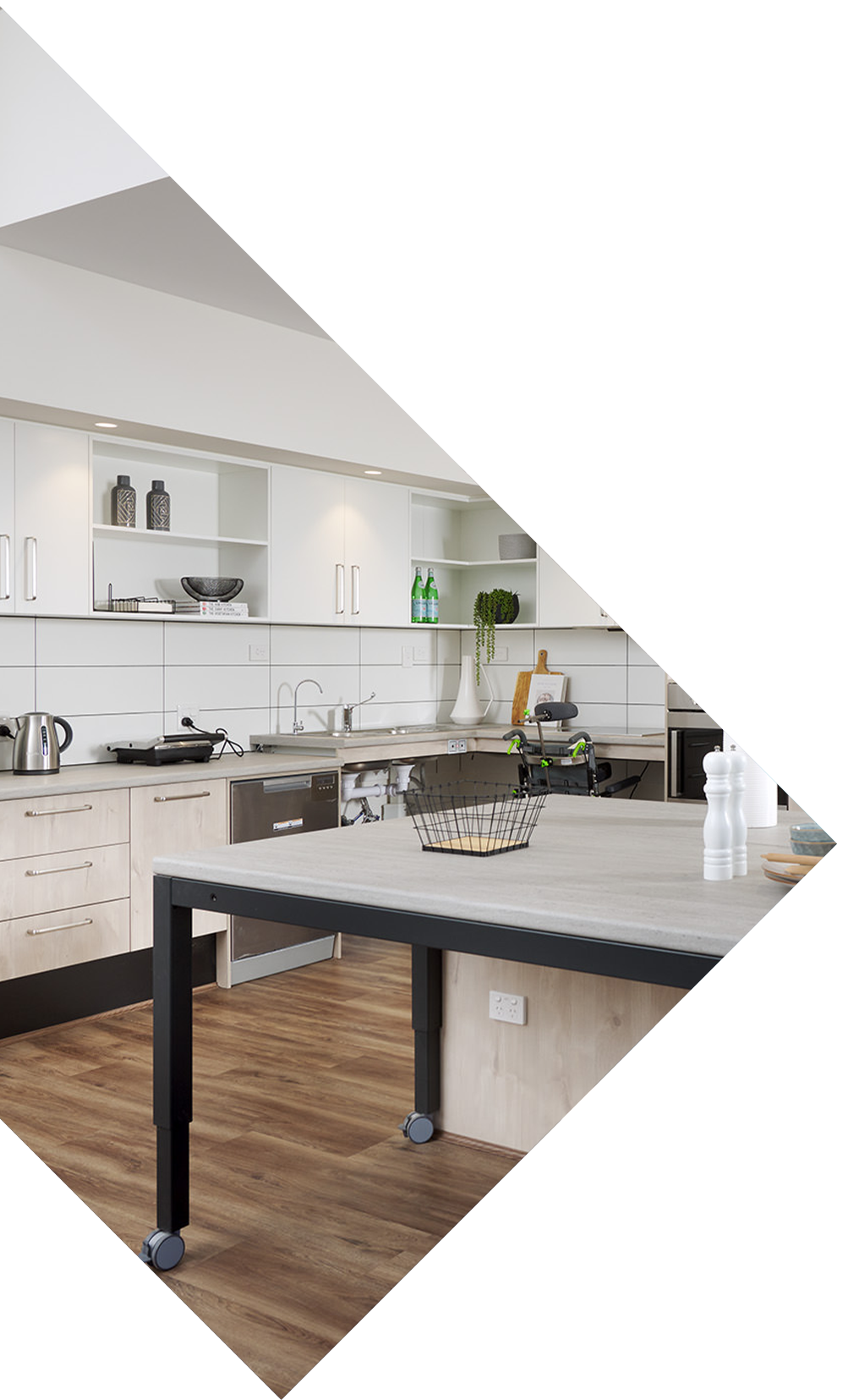 A stylish SDA approved kitchen appointed with custom features and wooden floors.