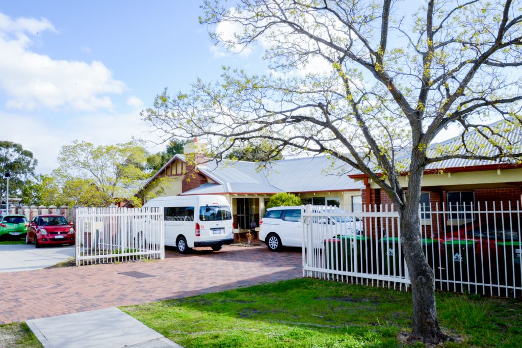 Nice sunny day showing front of the home with parked vans